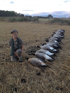 My oldest son, and the geese from Saturday evening's hunt.